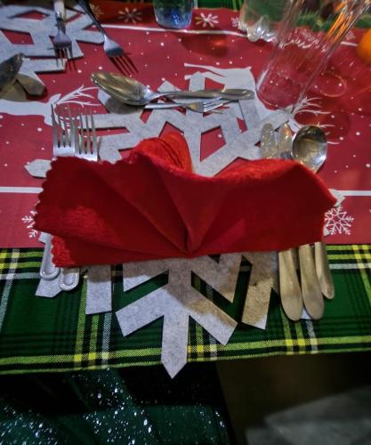 a table with a red napkin and utensils on a table at Amanya 3-Bedroom Hut Amboseli in Amboseli