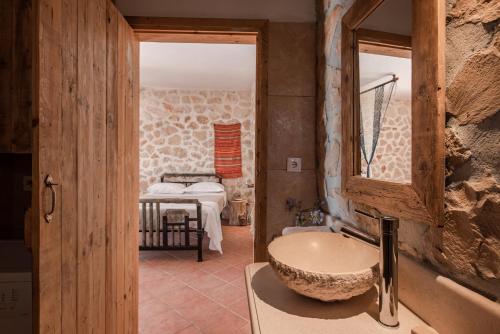 a bathroom with a sink and a mirror at Anemos in Koríthion