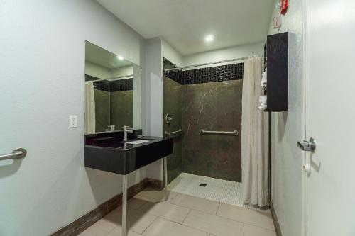 a bathroom with a sink and a shower at Xpress Inn & Extended Stay in Marshall