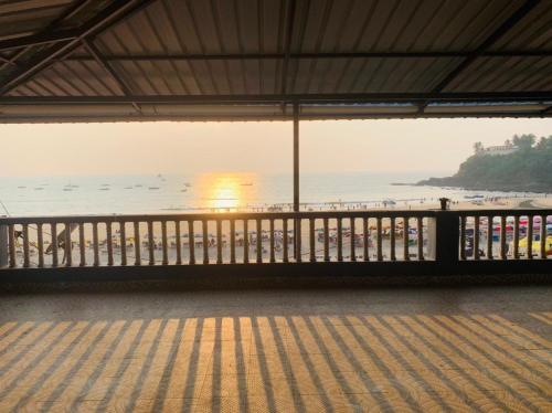 a balcony with a view of the beach at Baga Beach Sunset in Baga