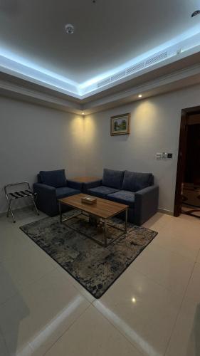 a living room with a couch and a coffee table at La Richy Jeddah in Jeddah