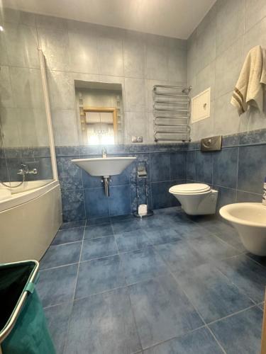a bathroom with a sink and a toilet at WhiteFort apartment in Almaty
