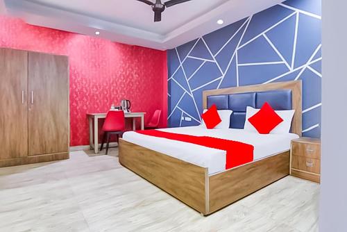 a bedroom with a bed with red and blue walls at The Nizamuddin palace in New Delhi
