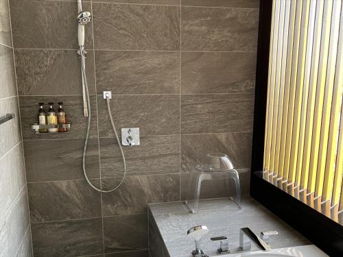 a bathroom with a shower and a sink at THE BLOSSOM KUMAMOTO in Kumamoto