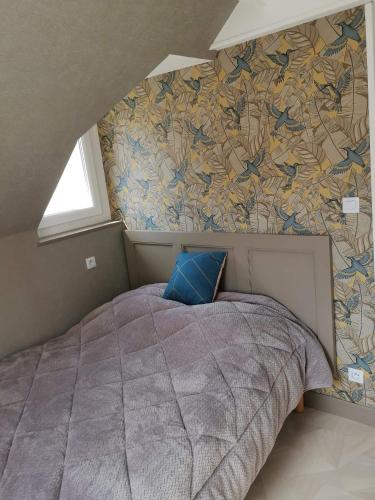 - une chambre avec un grand lit et une fresque murale dans l'établissement EVASION, à Fort-Mahon-Plage