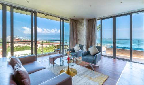 a living room with a view of the ocean at KOI Resort & Residence Da Nang in Da Nang