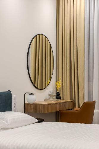 a bedroom with a bed and a mirror on the wall at FORUM apart in Lviv