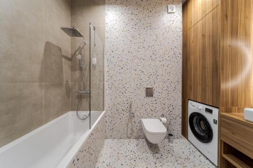a bathroom with a toilet and a shower and a sink at FORUM apart in Lviv