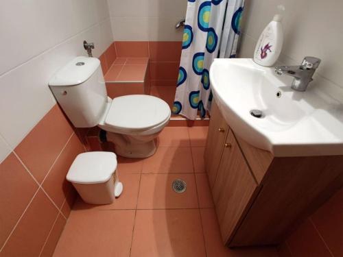 a bathroom with a toilet and a sink at Plateia Home in Karditsa