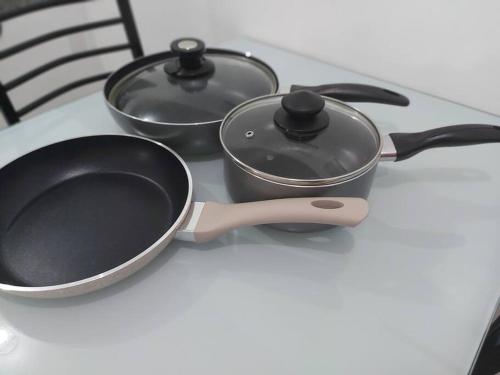 two pots and pans sitting on a table at Transient in Bria Homes in General Santos