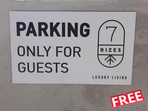 a sign on a wall that says parking only for guests at 7Rizes Luxury Living in Heraklio