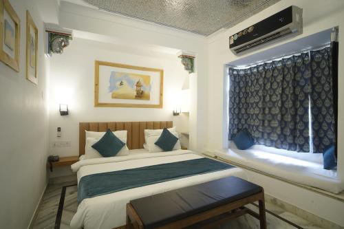 a hotel room with a bed and a window at Banjara Retreat in Udaipur