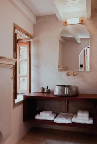 a bathroom with a sink and a mirror at Castellorizon Pensione in Meyisti