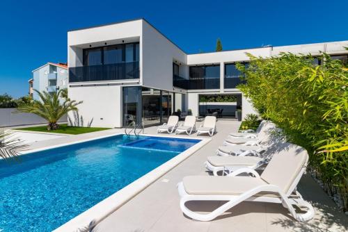 an image of a villa with a swimming pool at Villa Miaa newly built modern villa in Medulin for 9 people with heated swimming pool & jacuzzi in Medulin