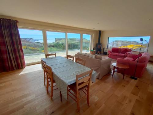 a living room with a table and a couch at 3 bed in Scourie SU164 in Rhiconich