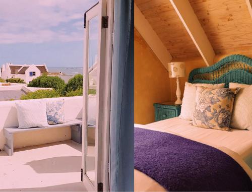 a room with a bed and a view of the ocean at Hocus Pocus Cottage in Paternoster