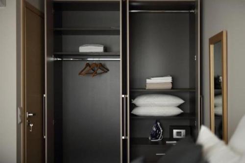 a walk in closet with towels and a mirror at Hector Luxury Suite in Athens