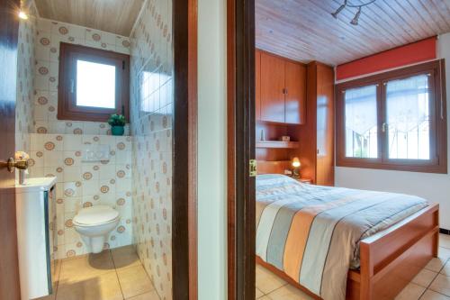 a bedroom with a bed and a toilet in a room at Falguera in L'Escala