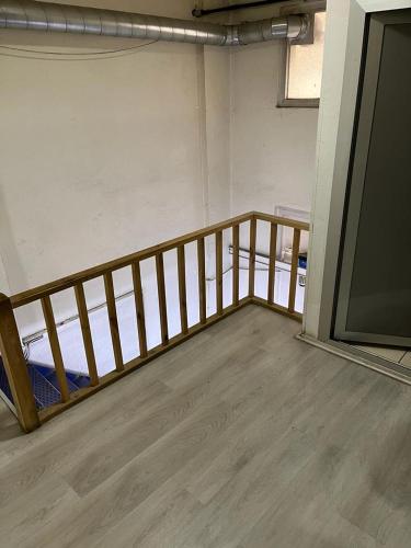 a room with a wooden railing in a room at Sahin Home Office in Istanbul
