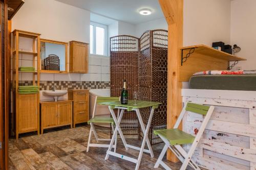 a room with a table and chairs and a bunk bed at Penzion Jizera Malá Skála in Malá Skála
