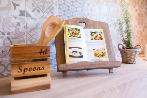 a book sitting on top of a table next to a sign at Villa Roza in Central Istria with whirlpool and playground for kids - pet friendly in Tinjan