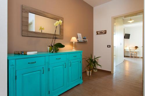 a blue cabinet in a room with a mirror at Villa Roza in Central Istria with whirlpool and playground for kids - pet friendly in Tinjan