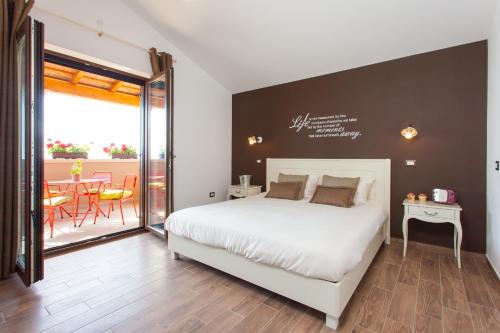 a bedroom with a bed and a table and a balcony at Villa Roza in Central Istria with whirlpool and playground for kids - pet friendly in Tinjan