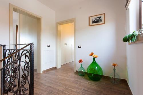 two green vases sitting on the floor in a hallway at Villa Roza in Central Istria with whirlpool and playground for kids - pet friendly in Tinjan