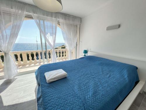 a bedroom with a blue bed and a large window at Villa Les Issambres, 4 pièces, 7 personnes - FR-1-632-4 in Les Issambres