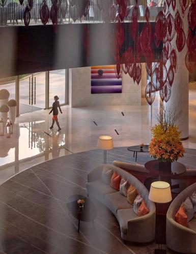 a living room with a couch and a person on a skateboard at Marco Polo Wuhan in Wuhan