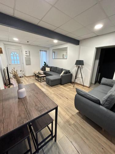 a living room with a couch and a table at Maison centre ville avec jardin in Challans