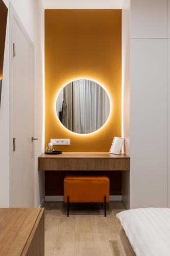 a bedroom with a mirror and a dressing table at FORUM apart in Lviv