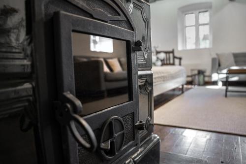 a living room with a fireplace with a couch at Százéves ház - Vérteskozma 48 in Gánt