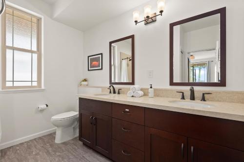a bathroom with a sink and a toilet and a mirror at Aloha Breeze by AvantStay Ocean View Near Beach in Waianae