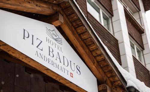 a sign for the front of a building at Hotel Piz Badus in Andermatt