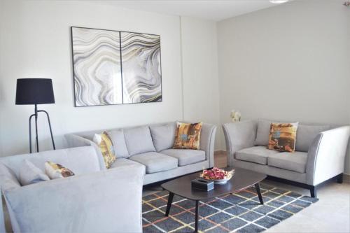 a living room with two couches and a coffee table at Luxurious Superior Apartment One Bedroom Space available in Accra