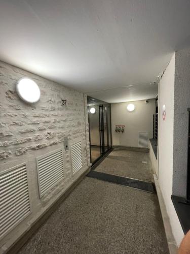 a hallway of a building with closed garage doors at Appartement Lahcen in Thorigny-sur-Marne