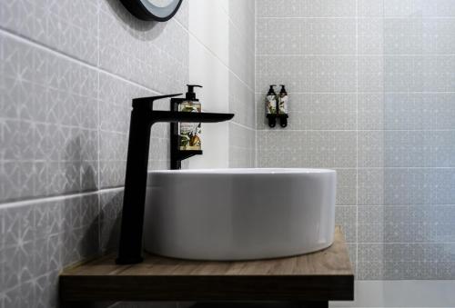 a bathroom with a white tub and a sink at Boutique Wine Hotel Panorama in Macedo de Cavaleiros