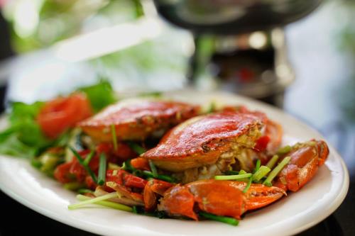 a plate of food with meat and vegetables on a table at Bangnu Greenery Resort in Takua Thung