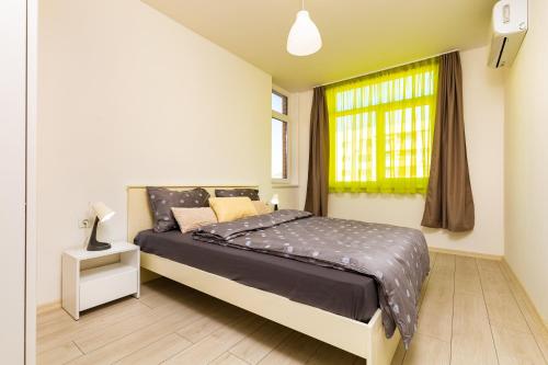 a bedroom with a bed and a window at Radiant Retreat: Bright 1BD Haven in Plovdiv in Plovdiv