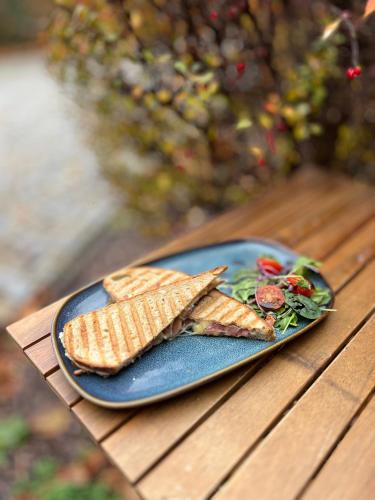 a blue plate with crackers and salad on a table at Penzion LaCasa in Vysoké Mýto