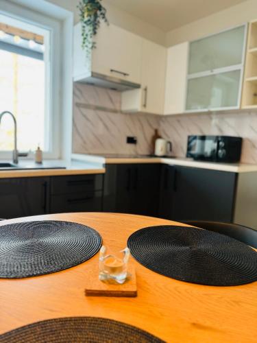 a wooden table with two plates on it in a kitchen at Villa Vincentów in Myślenice