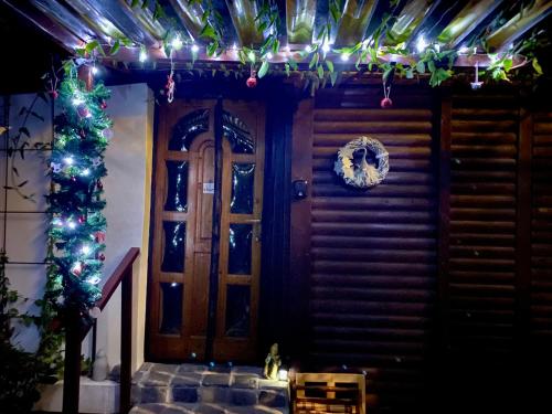a house with christmas lights and a door at Szegfű33 Vendégház in Zebegény