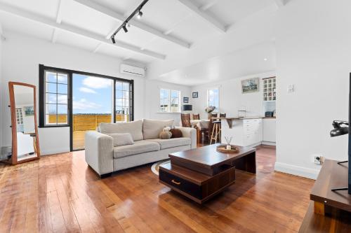 a living room with a couch and a table at Albert.T Home in Auckland