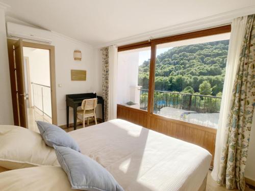 a bedroom with a bed and a large window at Spanish Connection - La Manga Golf Club in Atamaría