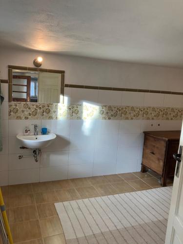 a bathroom with a sink and a mirror at Chalupa Barbolica in Vernár