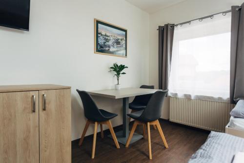 a small room with a table and two chairs at Ubytování Kytín in Kytín