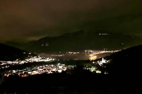 a view of a city at night with lights at Trento, Monte Bondone, casa tipica di montagna in Norge
