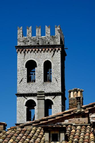 a tower on top of a building with windows at Chiama Ride the Beauty Assisi in Assisi