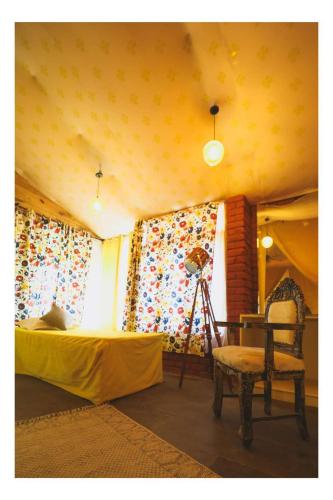 a bedroom with a bed and a lamp and a chair at Aranya by Stories in Jaipur
